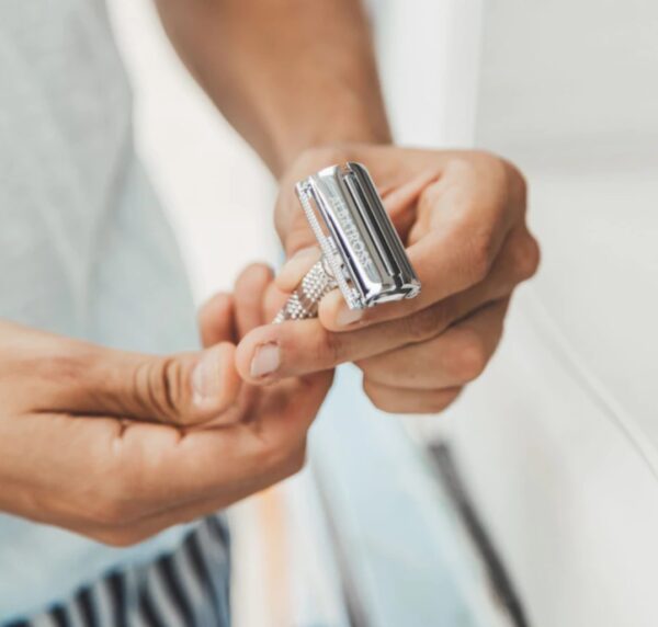 Close up of eco-friendly metal safety razor in man's hands