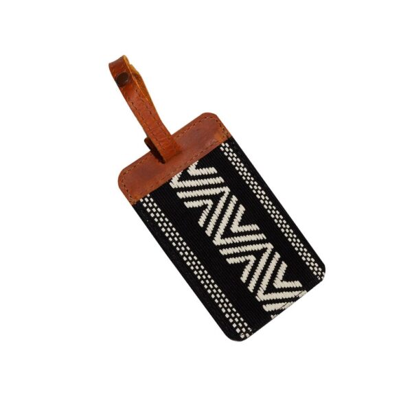 Global Goods Partners brand luggage tag in black with white zig zag embroidery, finished with a sturdy leather trim