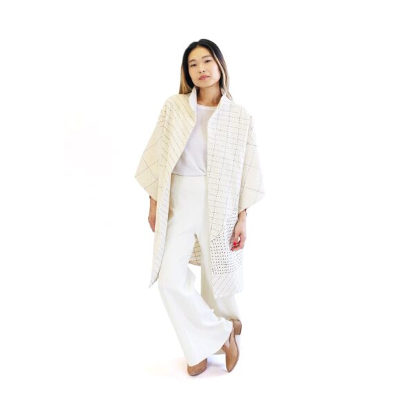 Woman wearing a sustainable handmade long kimono canvas jacket in bone white made by Anchal brand.