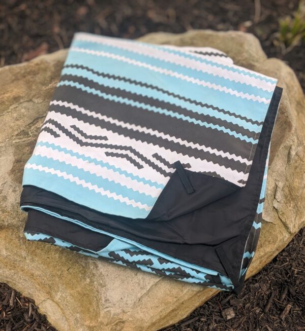 View of recycle, water resistant travel festival blanket in Baja Aqua