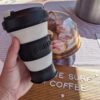 Eco-friendly collapsible Pokito coffee cup at a market coffee booth
