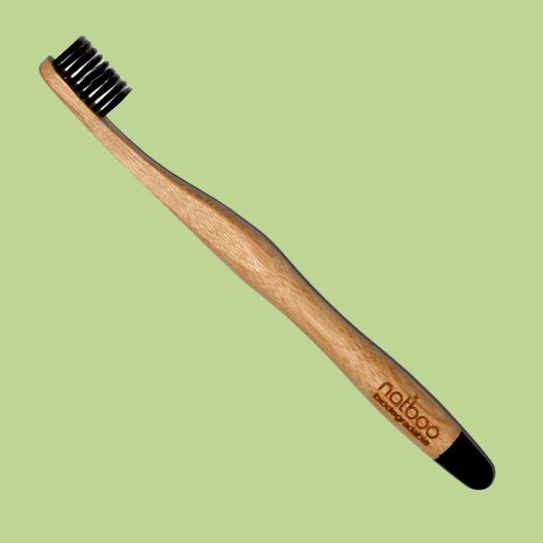 Natboo brand biodegradable round bamboo handled black tipped toothbrush with black activated charcoal infused bamboo bristles.