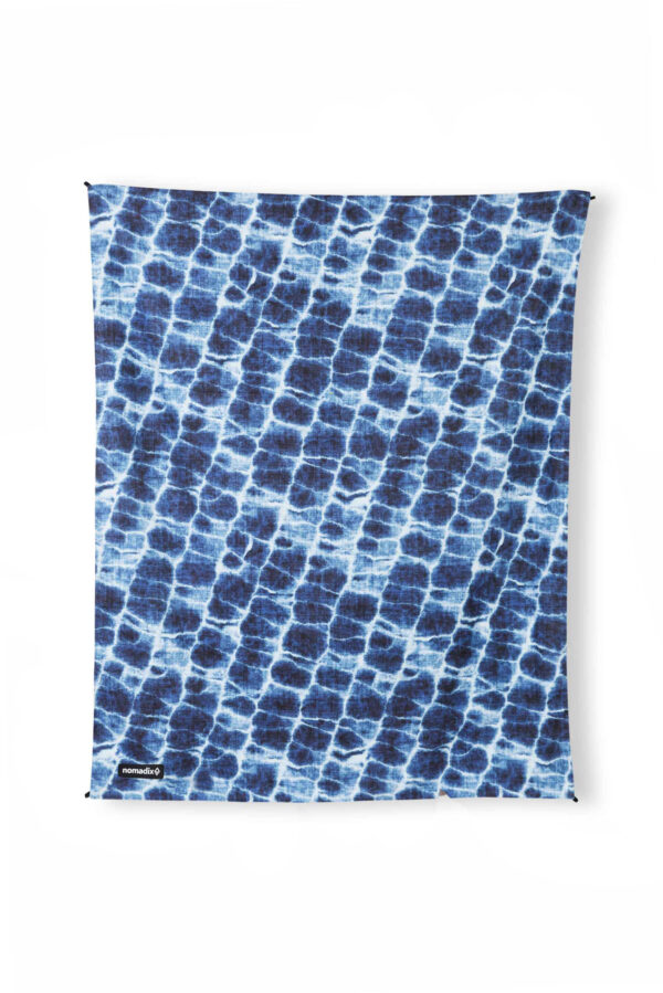 View of recycled, eco-friendly Agua Blue festival blanket and ground mat from Nomadix