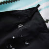 Close up of black water resistant back of Baja Aqua festival blanket and ground mat for festivals, camping and travel
