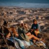 Couple at beach on sustainable Baja Aqua festival blanket and ground mat
