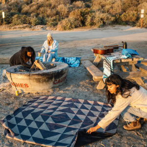 Group at the beach with eco-friendly festival blanket in Sierra Black Brown