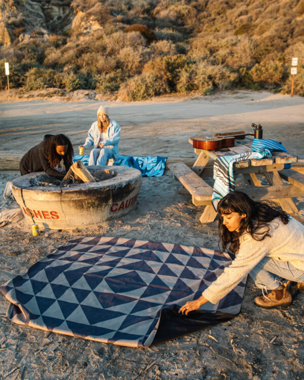 Group at the beach with eco-friendly festival blanket in Sierra Black Brown