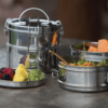 To Go Ware brand two tier tiffin lunch box set made of stainless steel; the lid doubles as a plate