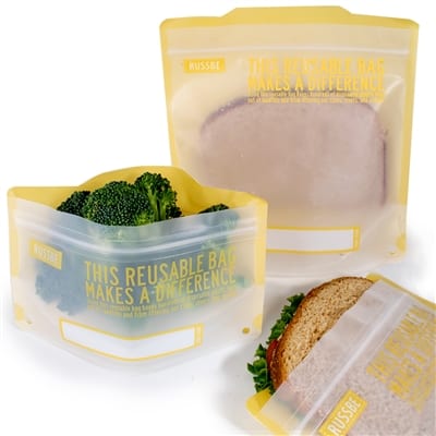 RussBe brand reusable bags in yellow; two shown holding sandwiches and another filled with broccoli