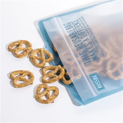 Pretzels spilling out of an open RussBe brand reusable sandwich bag in blue