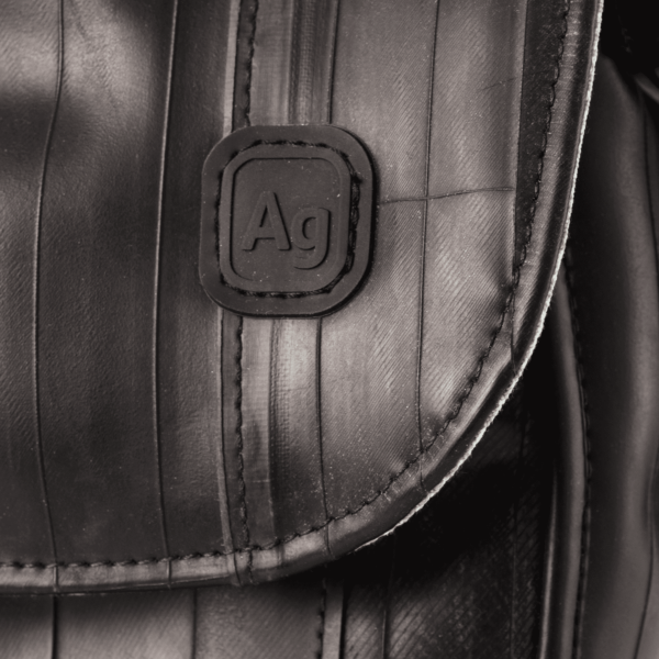 Close up of Alchemy Goods cross body purse showing stitching and AG logo