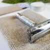 Albatross brand eco friendly plastic-free stainless steel flagship butterfly safety razor close up display on sustainable burlap bag.