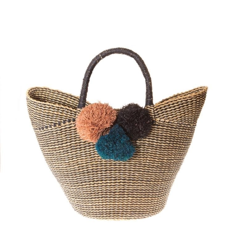 Global Goods Partners brand tote made of sustainably harvested raffia palm fiber, includes 3 colored pom poms