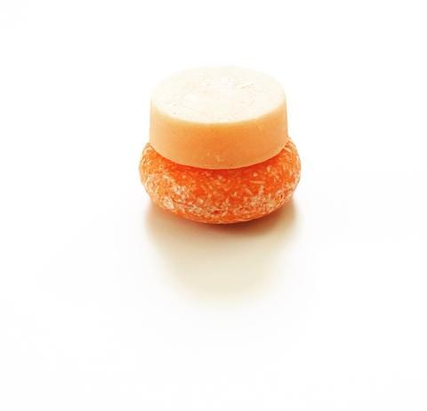 Pink Maverick brand zero waste solid shampoo and conditioner bars in tangerine and lemon scent; small and easy to pack for travel