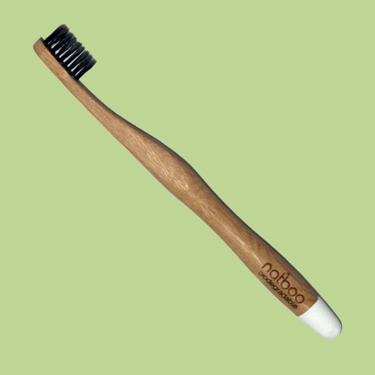 Natboo brand biodegradable bamboo round white tipped handled toothbrush with black bamboo charcoal infused bristles.