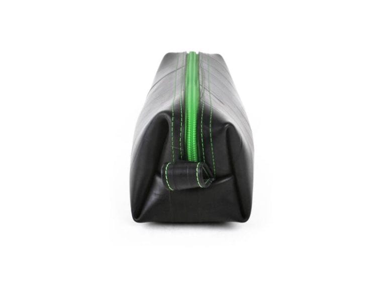 Small dopp kit by Alchemy Goods made of durable upcycled inner tubes; shown in black with lime green zipper.