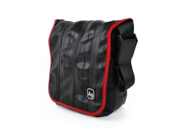 Small shoulder bag by Alchemy Goods made from upcycled bicycle inner tubes; side view to show adjustable shoulder strap.