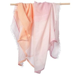 Bloom & Give brand peach and pink colored ultra-light cotton linen Bela Scarf draped over a rod.