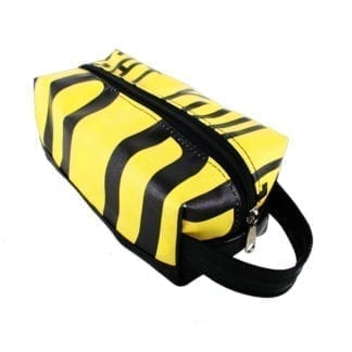 Alchemy Goods dopp kit made from upcycled advertising banners; shown in yellow and black.