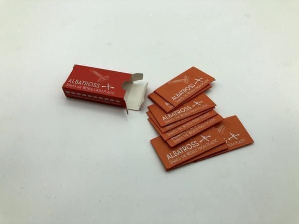 Albatross brand environmentally friendly orange and red razor blade box wrapper.