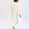 Backside display of woman wearing a sustainable handmade long kimono canvas jacket in bone white made by Anchal brand.