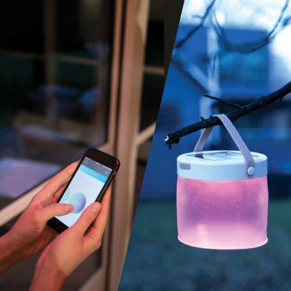 Sustainable Mpowerd brand Luci connect inflatable solar powered light hanging from tree branch with color control option displayed through smartphone app.