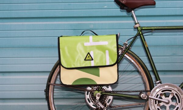 Close up shot of bike loaded up with the multi colored upcycled Double Dutch Pannier on rear wheel rack made by eco friendly Green Guru brand.