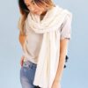 Earth friendly Anchal brand bone white Didi scarf handmade with sustainable 100% organic cotton, worn loosely wrapped around the neck of female model.