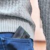 Close up of wallet in a pocket to illustrate compact size.