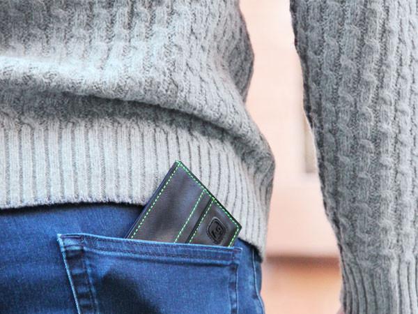 Close up of wallet in a pocket to illustrate compact size.