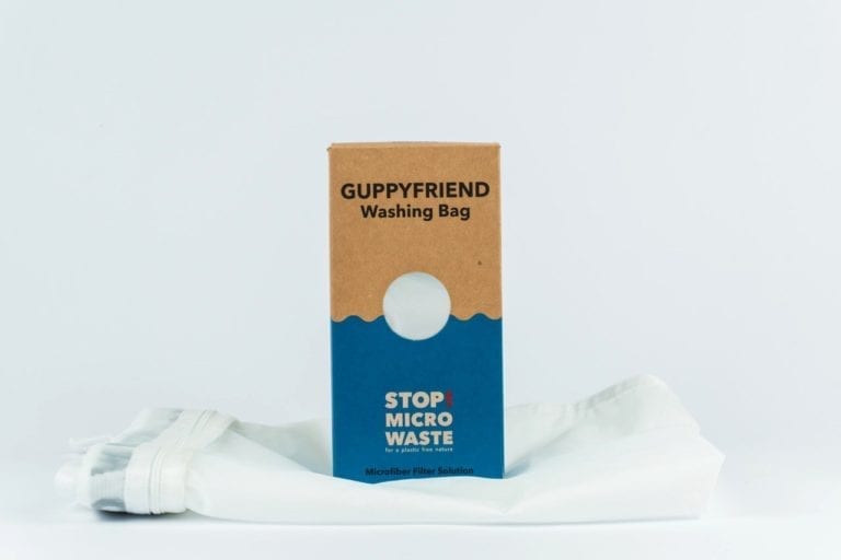 Environmentally friendly Guppyfriend brand anti-microplastic white laundry bag with sustainable recycled packaging.