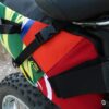 Close up photo of multicolor upcycled fabric Green Guru Gear brand Haluer Seat Bag Bike Pack displayed on white fat-tire bike with black seat.