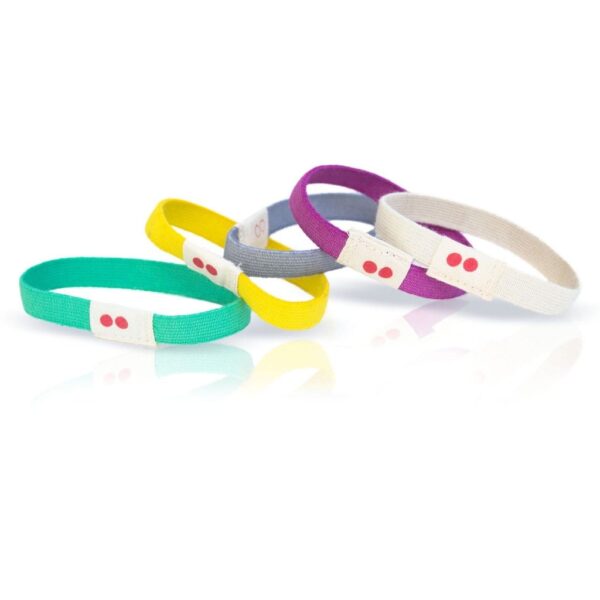Assortment of five multicolored KOOSHOO brand organic, plastic-free hair ties lying on.