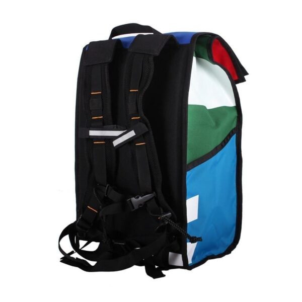 Backside angle view of eco friendly Green Guru Gear brand Joyride 24 liter storm-proof multi-color roll top backpack with black padded shoulder straps made from upcycled materials.