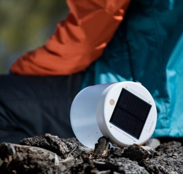 Inflatable, solar powered light sitting next to hiker
