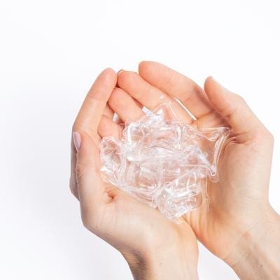 Dropps brand plastic free mini unscented plant-based laundry pods held in hand.