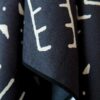 Close up product display of Mud Cloth pattern on recycled quick drying beach and yoga towel, made by Nomadix brand.