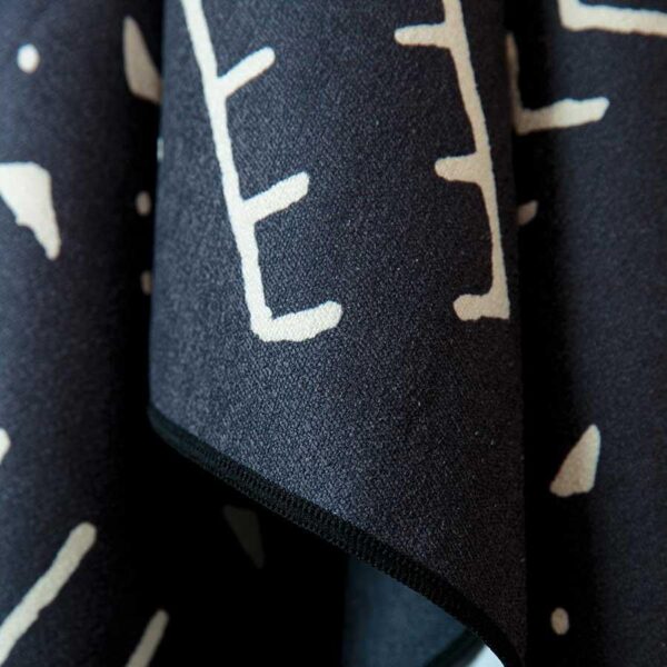 Close up product display of Mud Cloth pattern on recycled quick drying beach and yoga towel, made by Nomadix brand.