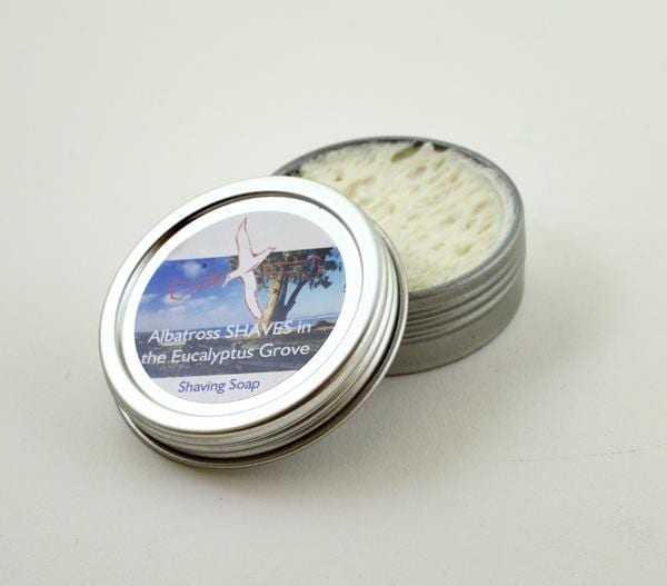 Albatross brand environmentally friendly Eucalyptus Shave Soap in travel tin with lid off.
