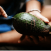 Mizu brand stainless steel reusable cutlery set; knife is shown cutting into an avocado