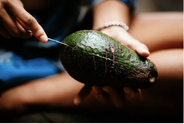 Mizu brand stainless steel reusable cutlery set; knife is shown cutting into an avocado