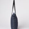 Side profile of the Ten Tree brand daily tote bag in dark blue with a waves print; made with REPREVE fabric and BLOOM foam padding