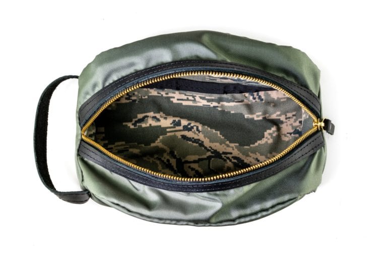 Sword & Plough dopp kit made of repurposed U.S. Air Force Fabric, camouflage interior and zippered closure shown