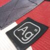 Detail showing upcycled seat belt strap and AG logo on the Alchemy large tote bag