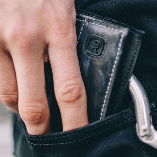 Close up of wallet in a pocket to illustrate compact size.