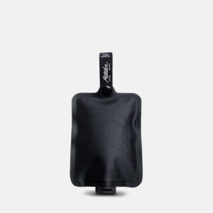 Vertical display of earth friendly all black Matador brand reusable toiletry bottle.