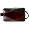 View of the large dopp kit from the top with unzipped zipper; shown in black with red zipper.
