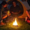 Four friends camping around Radiate Recycled Portable Campfire