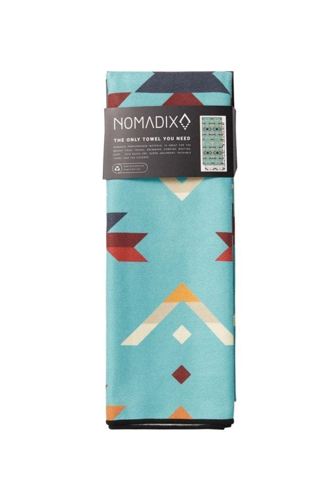 Product display of rolled up sustainable Nomadix brand, High alpine pattern, recycled quick drying beach and yoga towel.