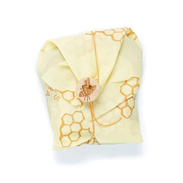 Beeswrap brand sandwich wrap with honeycomb print; use the string and bee button to secure food inside